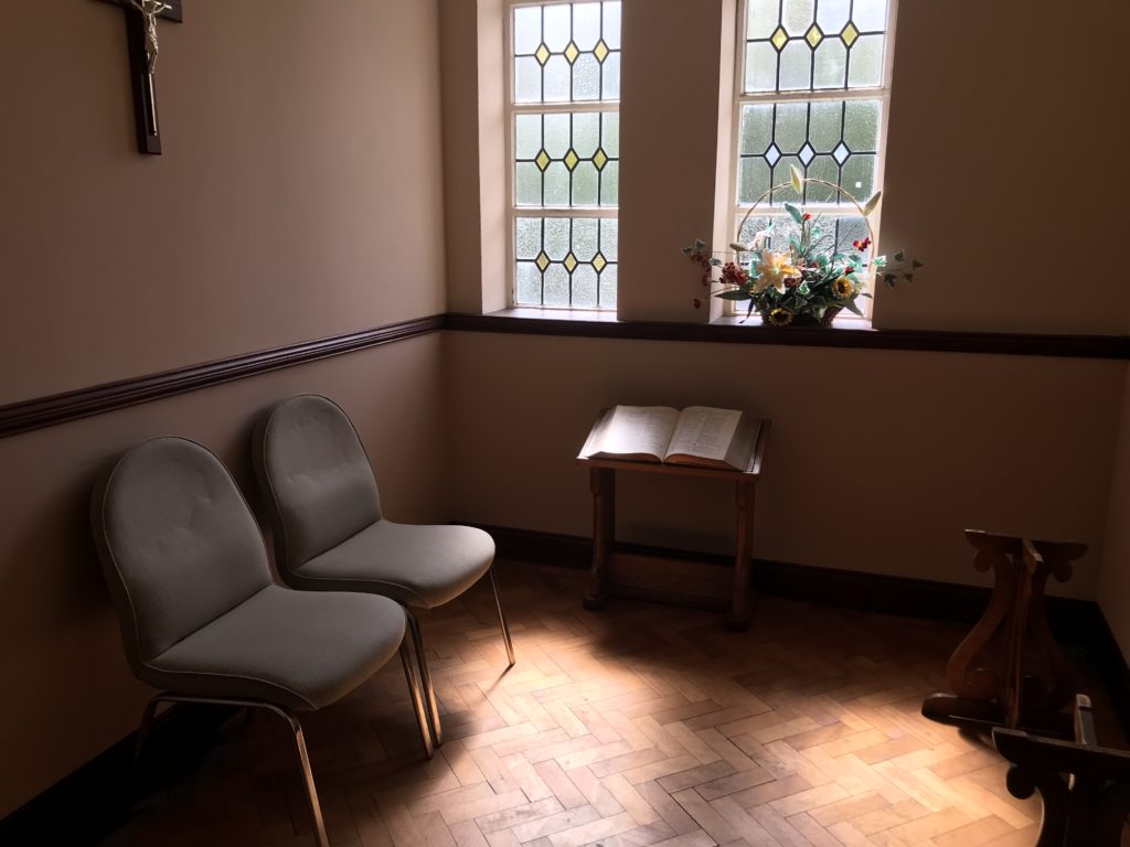 Inside of a funeral home in County Durham with stained glass windows